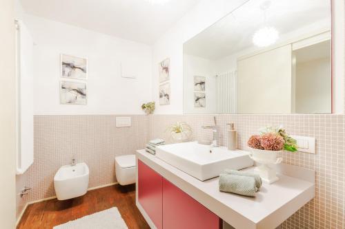 a bathroom with a white sink and a toilet at The Secret Escape Villa in Sant' Alessio