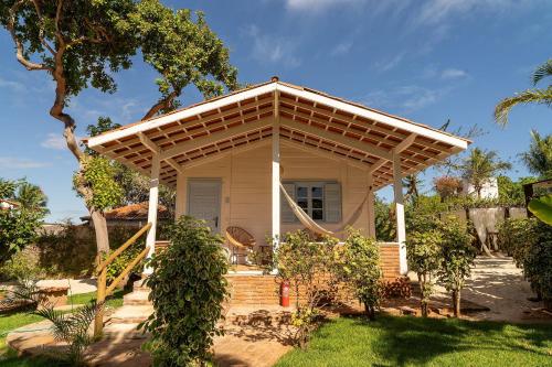 a small house with a pergola on top of it at FlowHouse Jeri - Hotel & Coworking in Jericoacoara