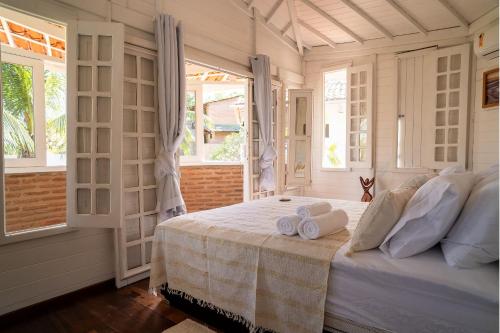 a bedroom with a bed with two towels on it at FlowHouse Jeri - Hotel & Coworking in Jericoacoara