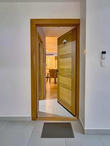 a hallway with a door leading to a dining room at Caribbean Nature Sourrounded Refuge Apartment in Juan Dolio