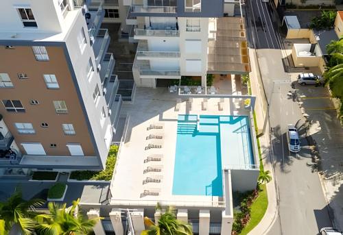 an overhead view of a building with a swimming pool at Caribbean Nature Sourrounded Refuge Apartment in Juan Dolio
