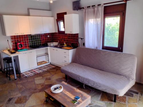 a living room with a couch and a table at MickeyHouse in Agria