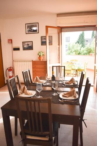 a dining room with a table with chairs and a table at Al Delfino Blu in Aurelia