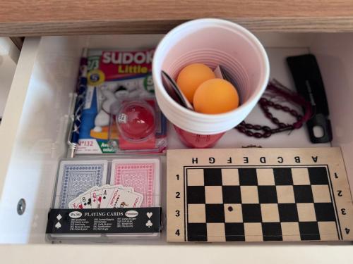 a box with a bowl of eggs and a chessboard at Home Louah Apartment Retreat in Oulad Tayeb