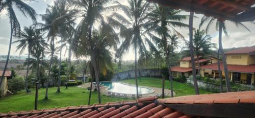 een uitzicht op een resort met een zwembad en palmbomen bij Villaggio Lagoa Das Palmeiras in Aquiraz