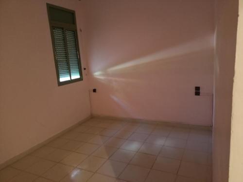 an empty room with a window and a tiled floor at Chwiter Marrakech in Chouiter