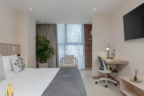 Una televisión o centro de entretenimiento en Solei Loft 303 - Modern Loft in Poblado with AC