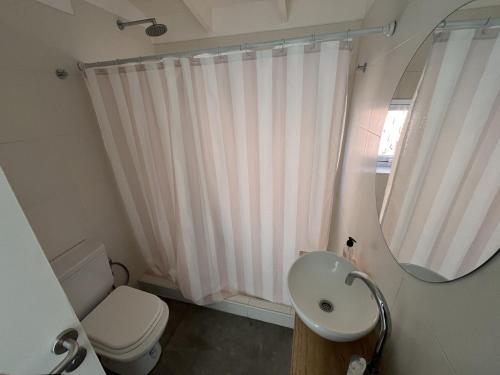 a bathroom with a white toilet and a sink at Olasanta - Casa en Chapa zona Cruz del Sur para 4 PAX con vista al mar - Hola Sur in Chapadmalal