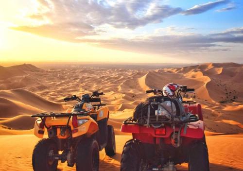 two atvs in the sand in the desert at Sahara Luxurious Tented in Merzouga