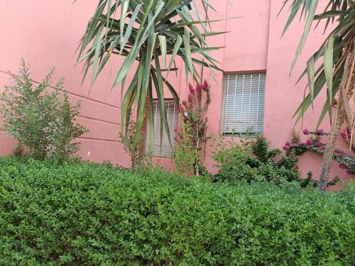 a pink building with plants in front of it at Chwiter Marrakech in Chouiter