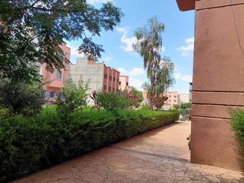 a walkway in a city with buildings and trees at Chwiter Marrakech in Chouiter