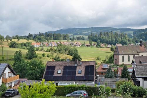 a village with solar panels on the roofs of houses at Ferienwohnung Veronika Heilbock in Sankt Peter