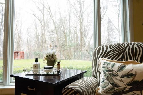 a living room with a zebra print chair and a coffee table at Audubon Acres l pool table & outdoor dining in Benton Harbor