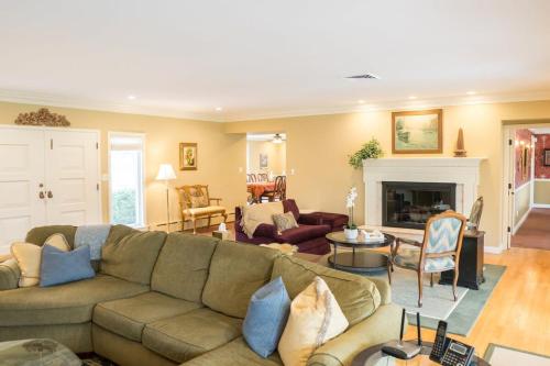 a living room with a couch and a fireplace at Audubon Acres l pool table & outdoor dining in Benton Harbor