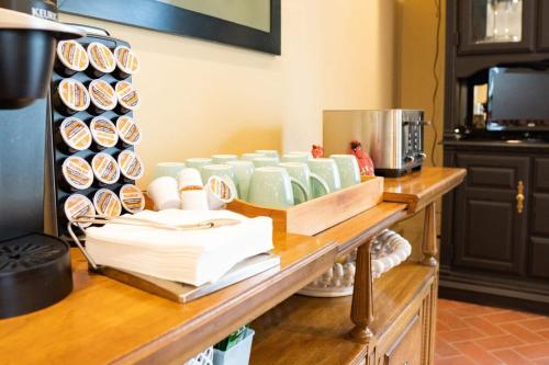 a counter with cups and plates on a table at Audubon Acres l pool table & outdoor dining in Benton Harbor