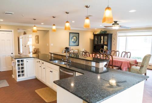 a kitchen and living room with a dining room at Audubon Acres l pool table & outdoor dining in Benton Harbor
