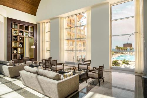 a living room with two couches and a table at Radisson Blu Resort & Spa Cesme in Cesme