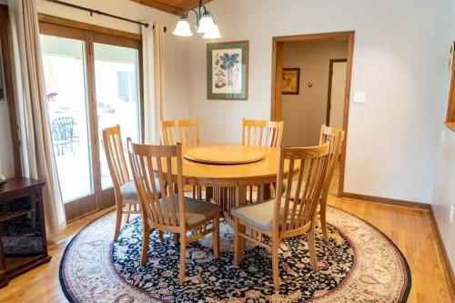 a dining room with a wooden table and chairs at Audubon Acres l pool table & outdoor dining in Benton Harbor