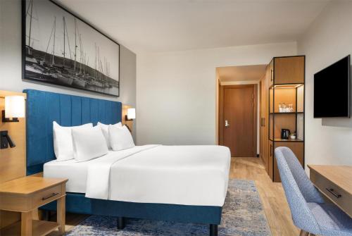a hotel room with a large bed and a desk at Radisson Blu Resort & Spa Cesme in Cesme