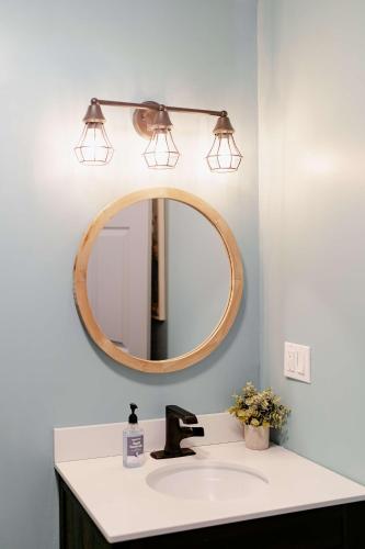 a bathroom with a sink and a mirror at Kevins Place near PawPaw Lake in Watervliet