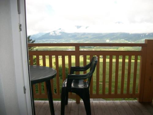 a table and chair on a balcony with a view at Agri-park Casa Miramonte in Ronzone