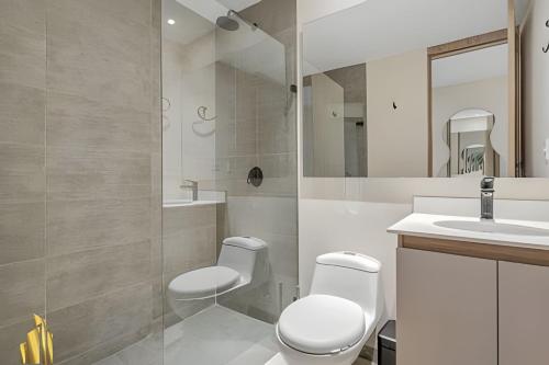 a bathroom with a toilet and a sink at Solei Loft 202 - Chic Studio with AC in El Poblado