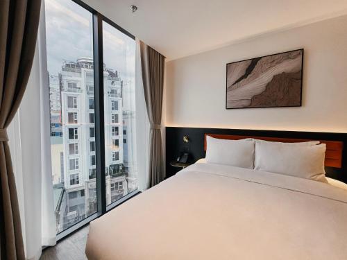 Cama o camas de una habitación en The Signature Hotel Saigon