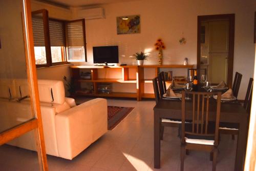 a living room with a table and a dining room at Al Delfino Blu in Aurelia