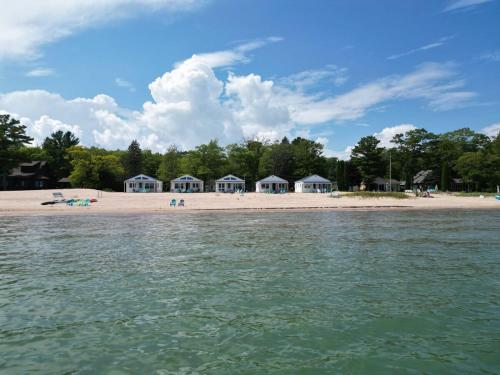a beach with a group of houses on the shore at New renovated bathroom & new roof - Lake Huron 4 in Lincoln Junction