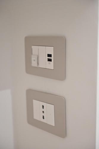 two electrical switches on a white wall at Domus Cassino Centro in Cassino