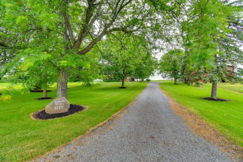 a gravel road in a park with trees at Cozy New York Farmhouse with Porch, Grill and Fire Pit in Yale