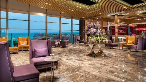 a lobby with purple chairs and a table with flowers at Crowne Plaza Florya Istanbul by IHG in Istanbul