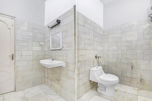 a bathroom with a toilet and a sink at Super Hotel O Alpine Glow Crest in Hyderabad