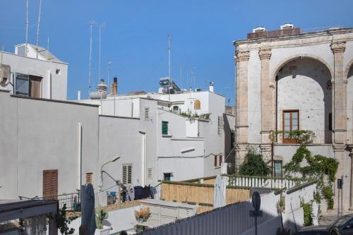 a group of white buildings and a building with an arch at Casa Tuccia in Ostuni