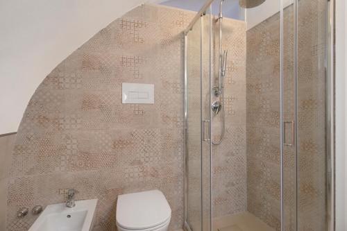 a bathroom with a shower and a toilet and a sink at Casa Tuccia in Ostuni