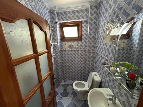 a bathroom with a toilet and a sink at Jb house in Chefchaouen