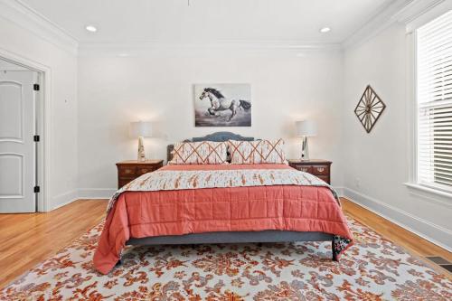 a bedroom with a bed with a red comforter at Luxury Retreat in Red Bank TN in Chattanooga