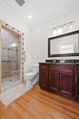 a bathroom with a toilet and a glass shower at Luxury Retreat in Red Bank TN in Chattanooga
