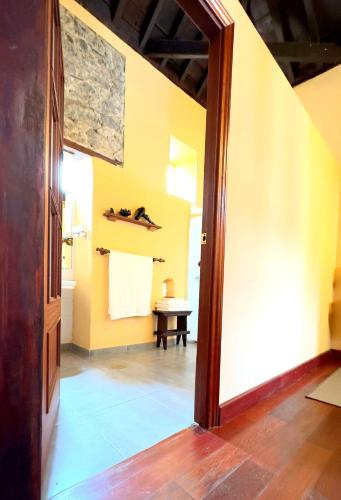a room with a hallway with a table and a door at Caletn Suites - Charming Farmhouse Retreat in Garachico, Tenerife in Garachico