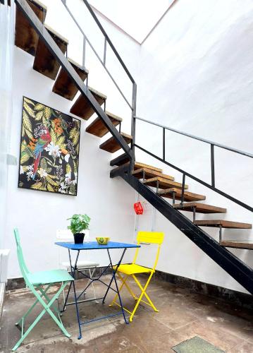 a table and chairs in a room with a staircase at Caletn Suites - Charming Farmhouse Retreat in Garachico, Tenerife in Garachico