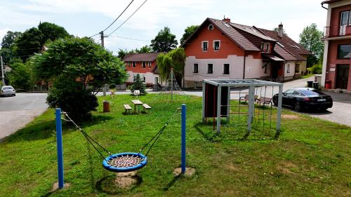 a playground with a swing set in the grass at Chalupa Tylda in Lhota