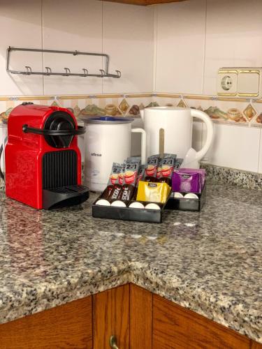 a kitchen counter with a toaster and some food at Casa Loto in Estepona