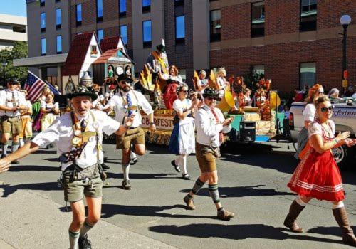 a group of people dancing in a parade at Gorgeous apartment across from La Crosse Center in La Crosse