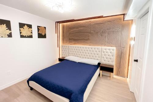 a bedroom with a blue bed and a window at Private Room Near Airport D9 in Brampton