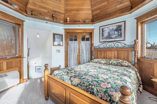 a bedroom with a bed and wooden ceilings and windows at Clarks Summit Gem w/ Private Yard & Parking in Newton Center
