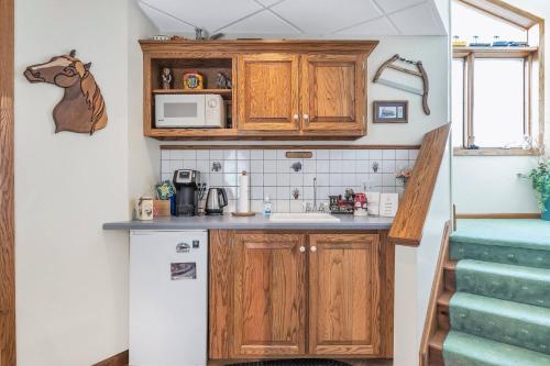 a small kitchen with wooden cabinets and a white refrigerator at Clarks Summit Gem w/ Private Yard & Parking in Newton Center