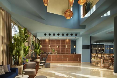 a lobby with a waiting area with a basketball on the ceiling at NH Alicante in Alicante