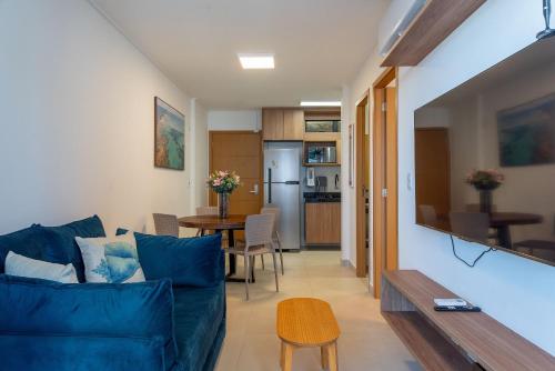 a living room with a blue couch and a table at Studio Design 3 Apt 812 Mandi Hospitalidade in Maceió