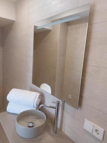 a bathroom with a sink and a mirror at Hotel Nuevo Ondina in Begur