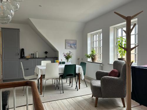 a kitchen and dining room with a table and chairs at Tjebberupgaard B&B in Holbæk